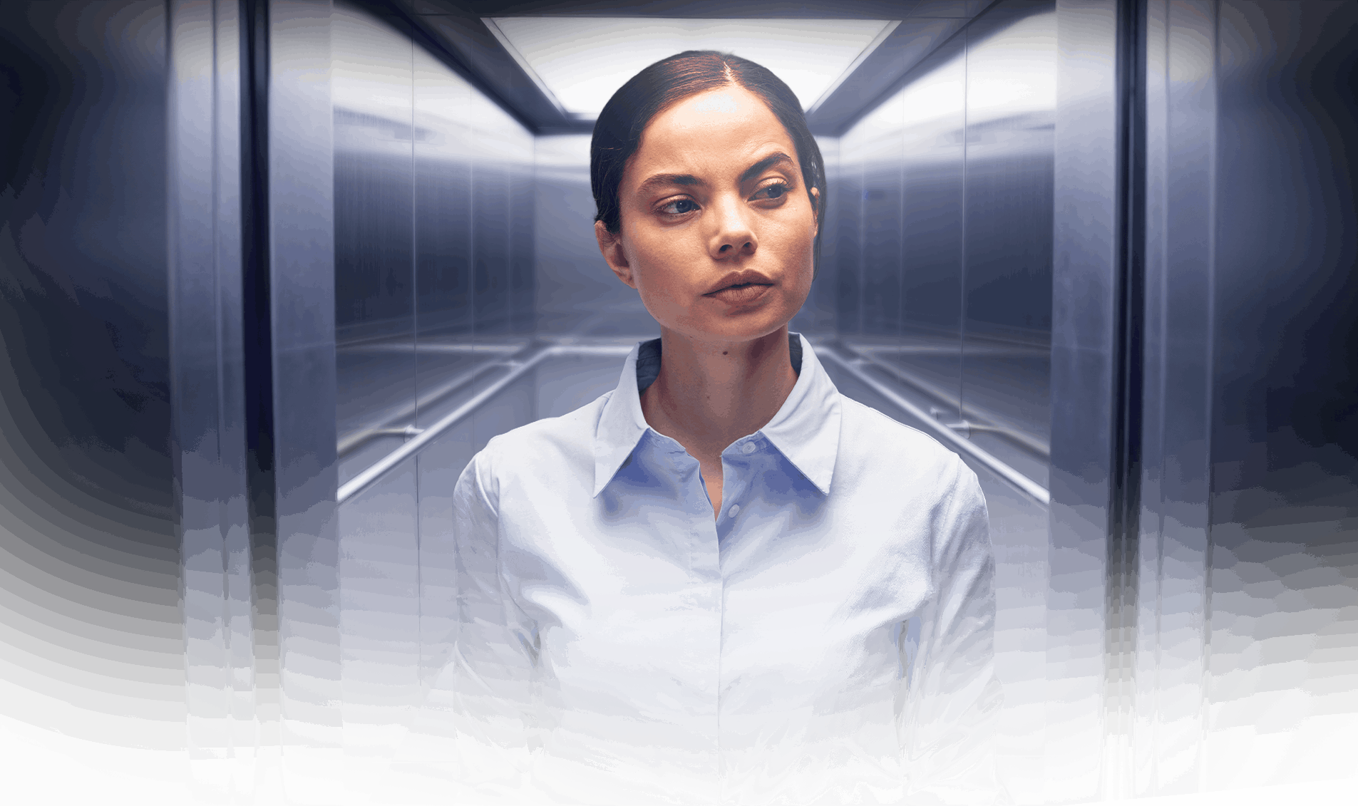 Two colleagues talking in an office elevator